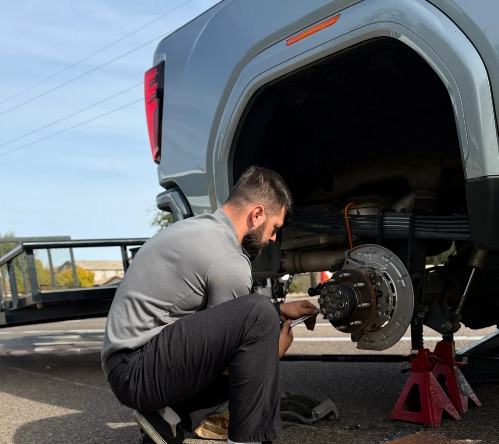 Monkey Wrench Automotive ASE-certified mechanic performing a mobile brake and wheel-hub repair roadside in the East Valley, Arizona